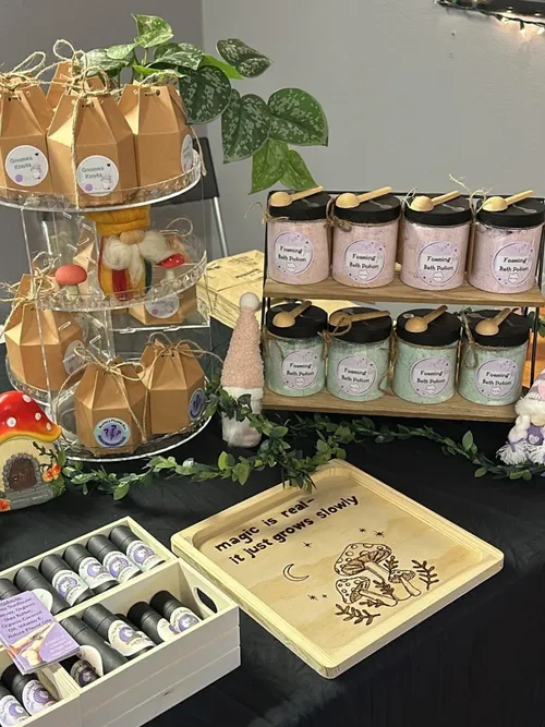 Gnome's Creations product display with bath bombs, candles, and gnome figurines